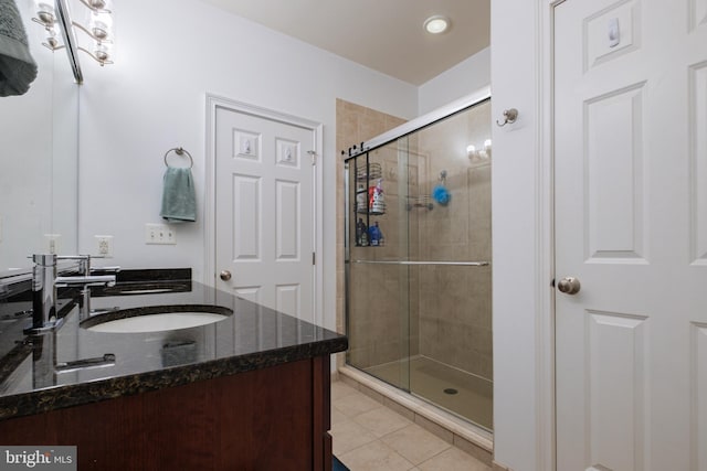 bathroom with a shower stall, tile patterned floors, vanity, and recessed lighting