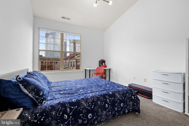 carpeted bedroom with vaulted ceiling
