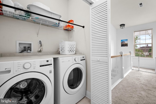 laundry room featuring independent washer and dryer, light carpet, and baseboards
