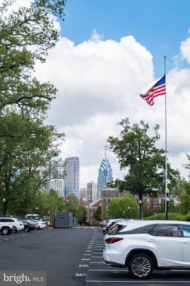 uncovered parking lot featuring a skyline view