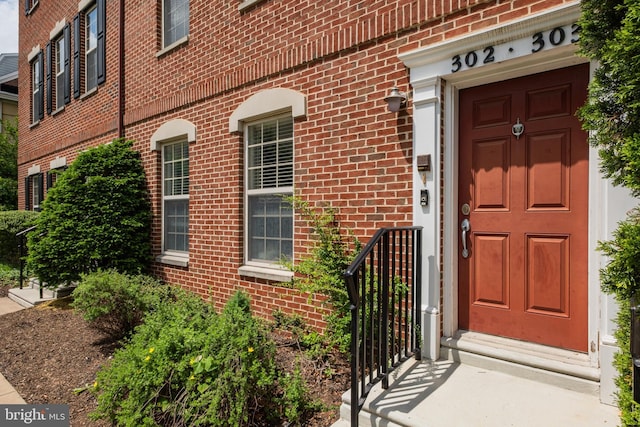 property entrance featuring brick siding
