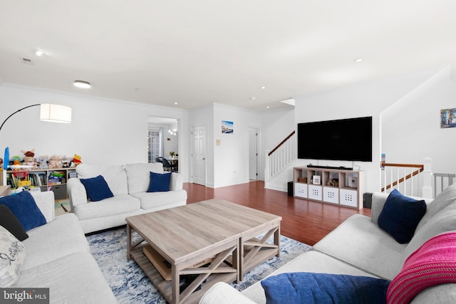 living area with stairs, crown molding, wood finished floors, and recessed lighting