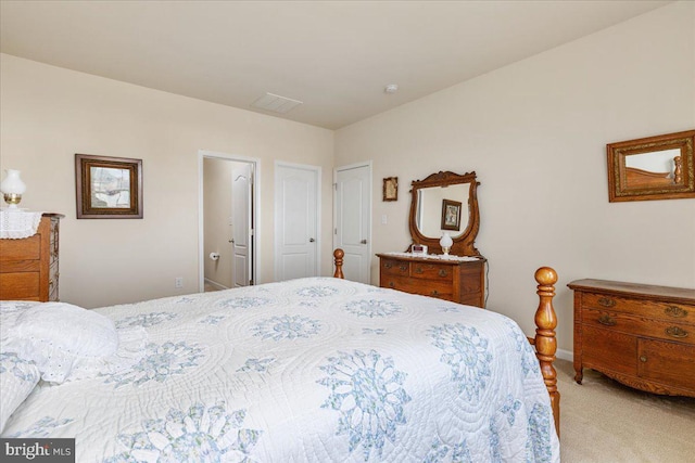 bedroom with light colored carpet and baseboards