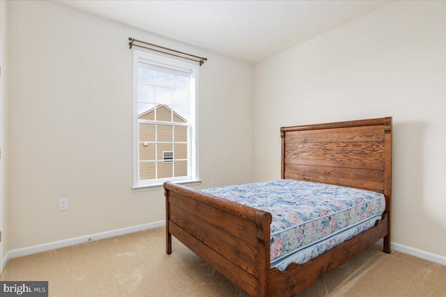 bedroom with baseboards and carpet floors
