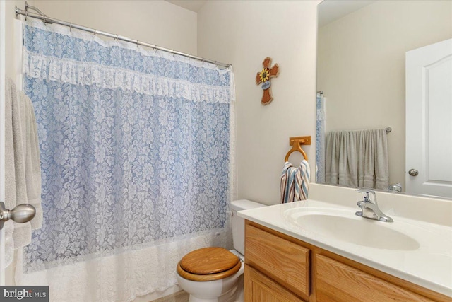 full bath with toilet, shower / tub combo, and vanity