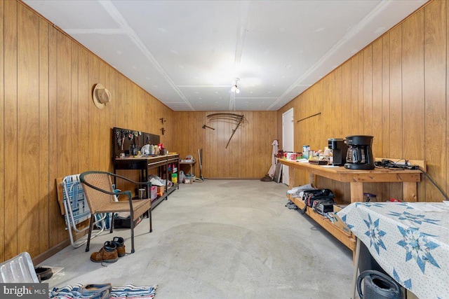 interior space featuring wooden walls and concrete flooring