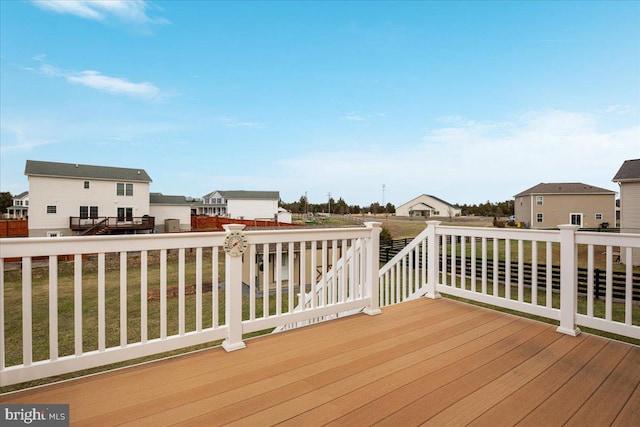 deck with a lawn and a residential view