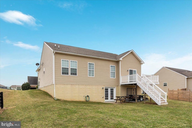 back of property featuring french doors, fence, a wooden deck, a yard, and stairs