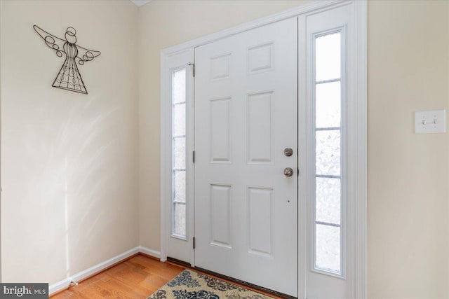 foyer featuring light wood finished floors and baseboards