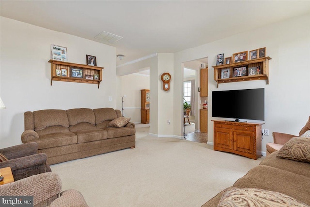 living room with light carpet, baseboards, and visible vents