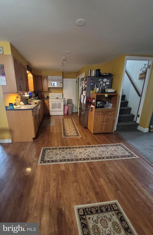 kitchen featuring freestanding refrigerator, white range with electric stovetop, dark wood finished floors, a sink, and light countertops