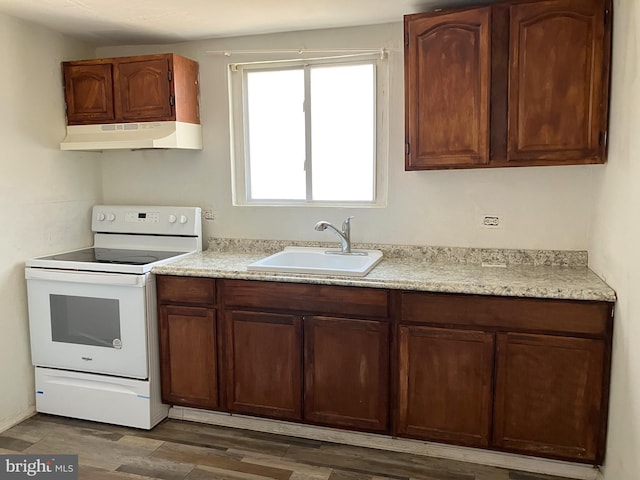 2008 E Orleans St, Philadelphia, PA 19134 - kitchen featuring electric range, under cabinet range hood, a sink, light countertops, and wood finished floors
