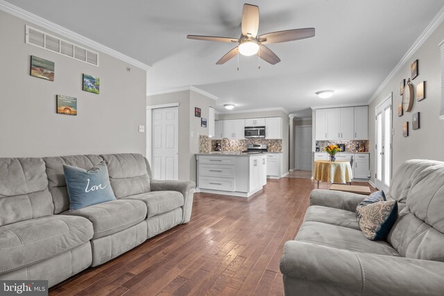 living room with ceiling fan, crown molding, and hardwood / wood-style flooring