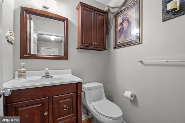 half bathroom with toilet and vanity