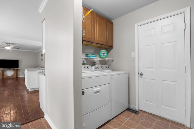 washroom with cabinet space, washer and clothes dryer, ceiling fan, crown molding, and baseboards