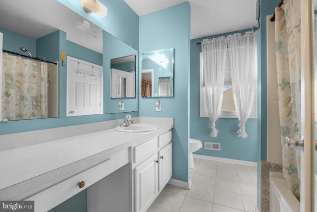 bathroom featuring tile patterned flooring, toilet, vanity, a shower with curtain, and baseboards