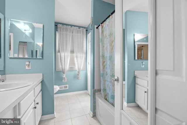 bathroom with vanity, tile patterned flooring, baseboards, and shower / tub combo with curtain