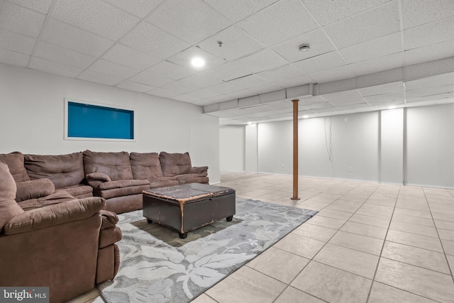 living room with tile patterned flooring and a drop ceiling