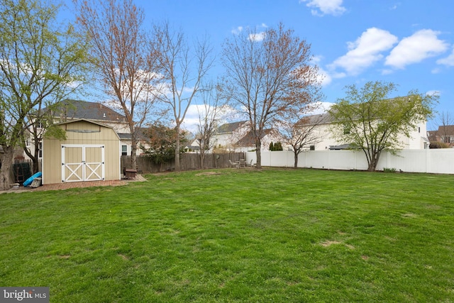 view of yard featuring a storage unit and an outdoor structure