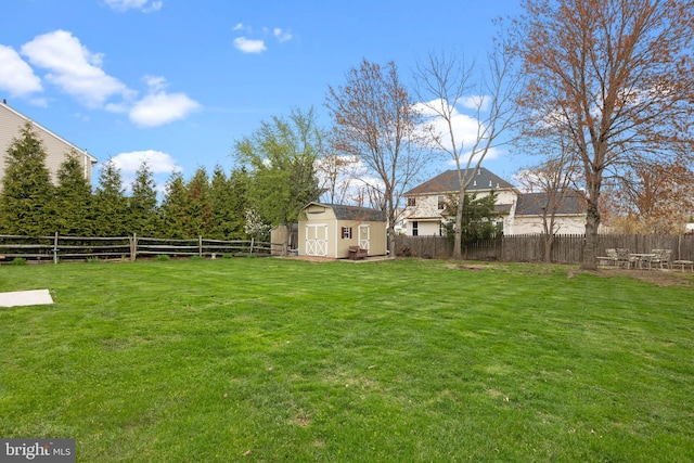 view of yard featuring a storage unit and an outbuilding