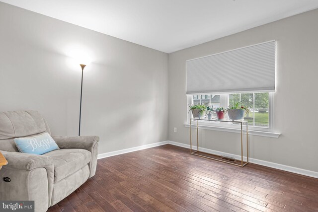 sitting room featuring dark wood-style flooring and baseboards