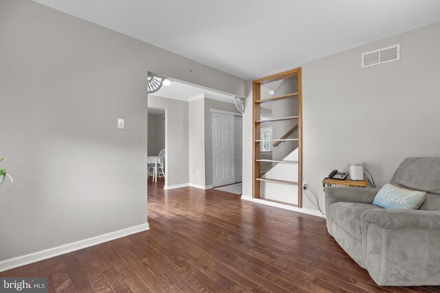sitting room featuring baseboards and dark wood-style floors