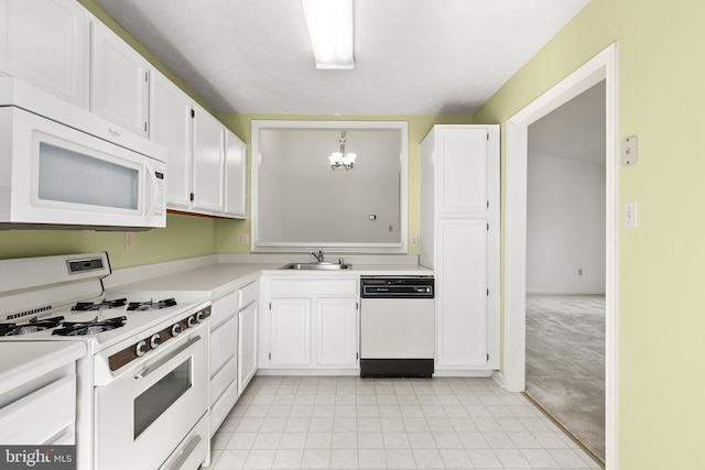 kitchen featuring white appliances, a chandelier, white cabinetry, light countertops, and light carpet