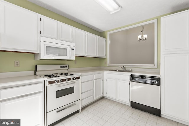 kitchen featuring white appliances, a sink, white cabinets, and light countertops