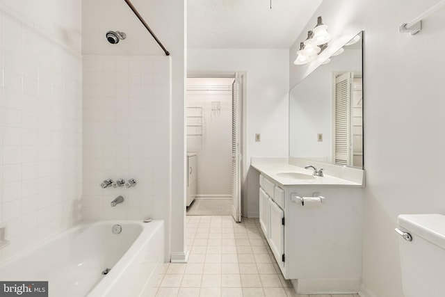 full bathroom featuring tile patterned flooring, bathing tub / shower combination, baseboards, vanity, and a closet