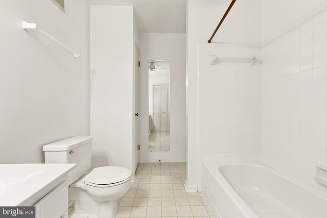 full bath with tile patterned floors, ceiling fan, toilet, washtub / shower combination, and vanity