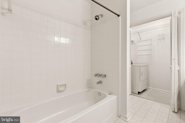 full bathroom with washer / clothes dryer, tile patterned floors, baseboards, shower / washtub combination, and vanity
