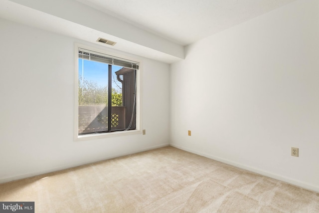 carpeted empty room with baseboards