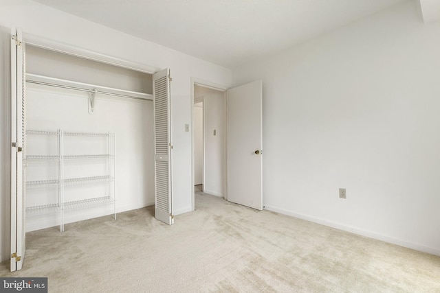 unfurnished bedroom featuring carpet flooring, a closet, and baseboards