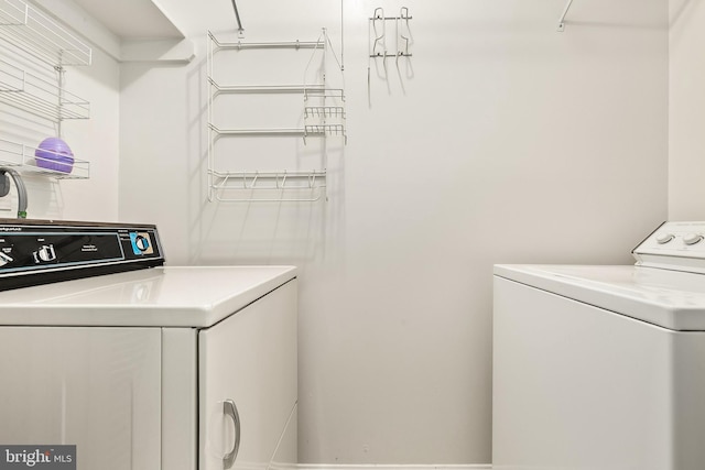 laundry room featuring washing machine and clothes dryer