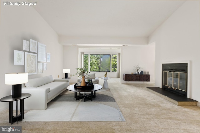 living area with carpet and a glass covered fireplace