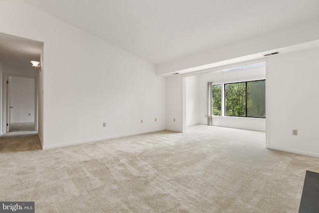 empty room with carpet and baseboards