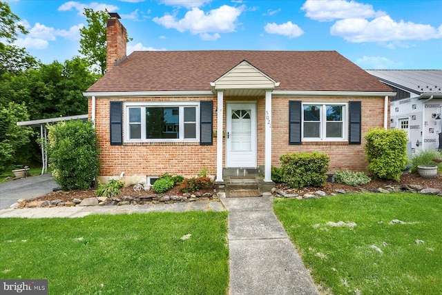 5021 Utah Ave, Harrisburg, PA 17109 - bungalow featuring brick siding, a chimney, a front lawn, and a shingled roof