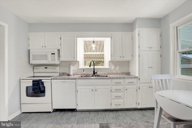 5021 Utah Ave, Harrisburg, PA 17109 - kitchen featuring white appliances, a sink, white cabinetry, light wood-style floors, and backsplash