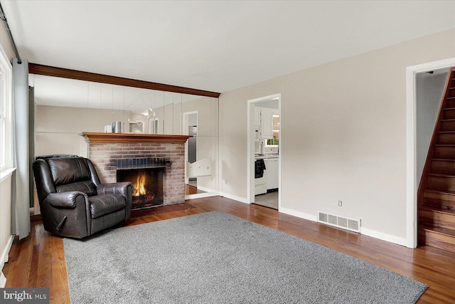 5021 Utah Ave, Harrisburg, PA 17109 - living area with a brick fireplace, wood finished floors, stairway, and baseboards