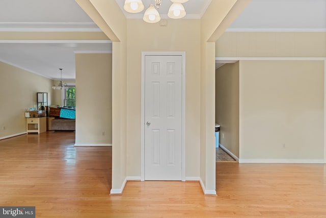 256 Frontier Trl, Lusby, MD 20657 - foyer entrance with a chandelier, crown molding, light wood finished floors, and baseboards