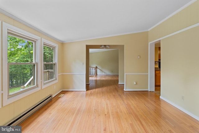 256 Frontier Trl, Lusby, MD 20657 - empty room featuring baseboard heating, light wood-style flooring, ornamental molding, and baseboards