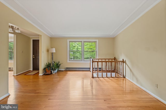 256 Frontier Trl, Lusby, MD 20657 - spare room with baseboard heating, light wood-style floors, baseboards, crown molding, and a baseboard heating unit