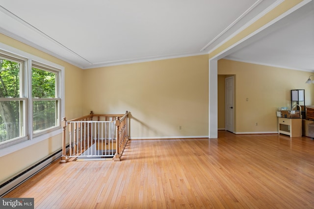 256 Frontier Trl, Lusby, MD 20657 - spare room with a baseboard heating unit, ornamental molding, wood-type flooring, and baseboards