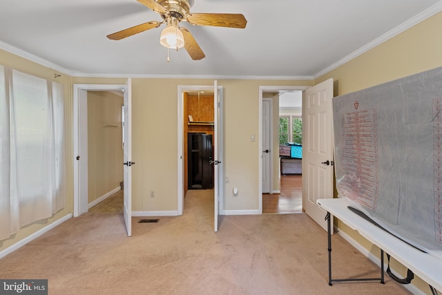 256 Frontier Trl, Lusby, MD 20657 - unfurnished bedroom featuring light carpet, crown molding, baseboards, and a ceiling fan