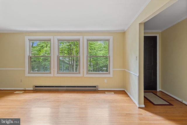 256 Frontier Trl, Lusby, MD 20657 - spare room featuring a baseboard radiator, plenty of natural light, crown molding, hardwood / wood-style floors, and baseboards