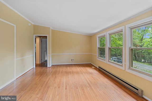 256 Frontier Trl, Lusby, MD 20657 - spare room featuring baseboard heating, crown molding, and light wood-type flooring