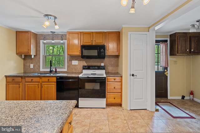 256 Frontier Trl, Lusby, MD 20657 - kitchen with black appliances, a sink, backsplash, crown molding, and baseboards