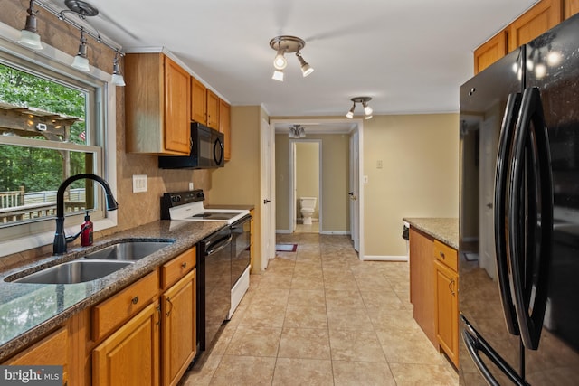 256 Frontier Trl, Lusby, MD 20657 - kitchen with black appliances, a sink, and brown cabinetry