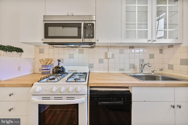 1954 Columbia Rd NW Unit 504, Washington, DC 20009 - kitchen with stainless steel microwave, white range with gas cooktop, dishwasher, a sink, and wooden counters