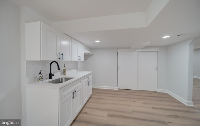 6802 Elbrook Rd, Lanham, MD 20706 - kitchen featuring light wood-style flooring, recessed lighting, baseboards, a sink, and light countertops